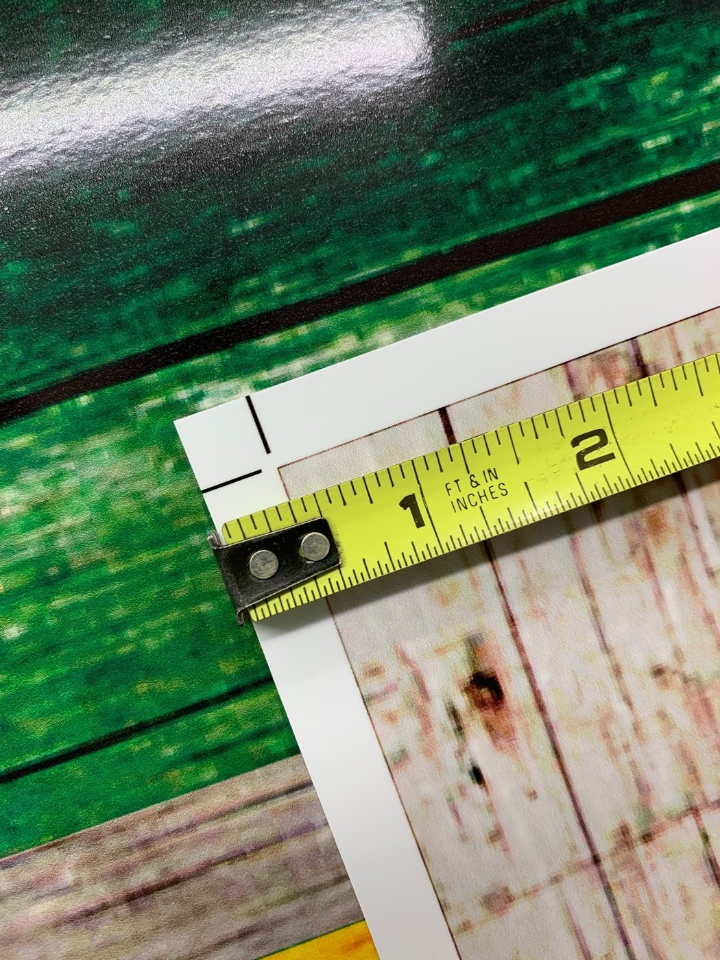 Tape measure showing the half-inch white trim border around a cornhole wrap