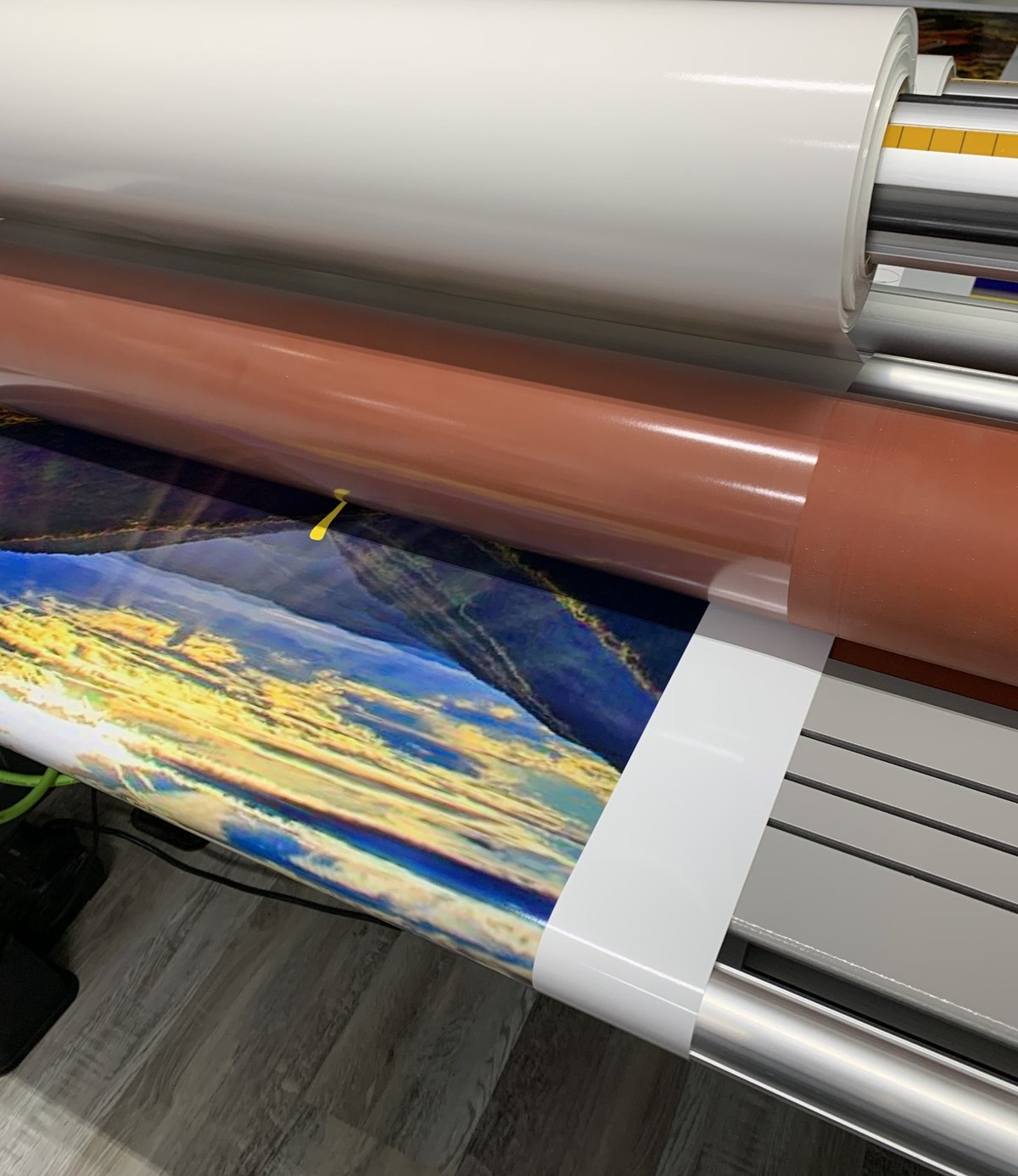 Custom cornhole wrap being printed on professional vinyl equipment
